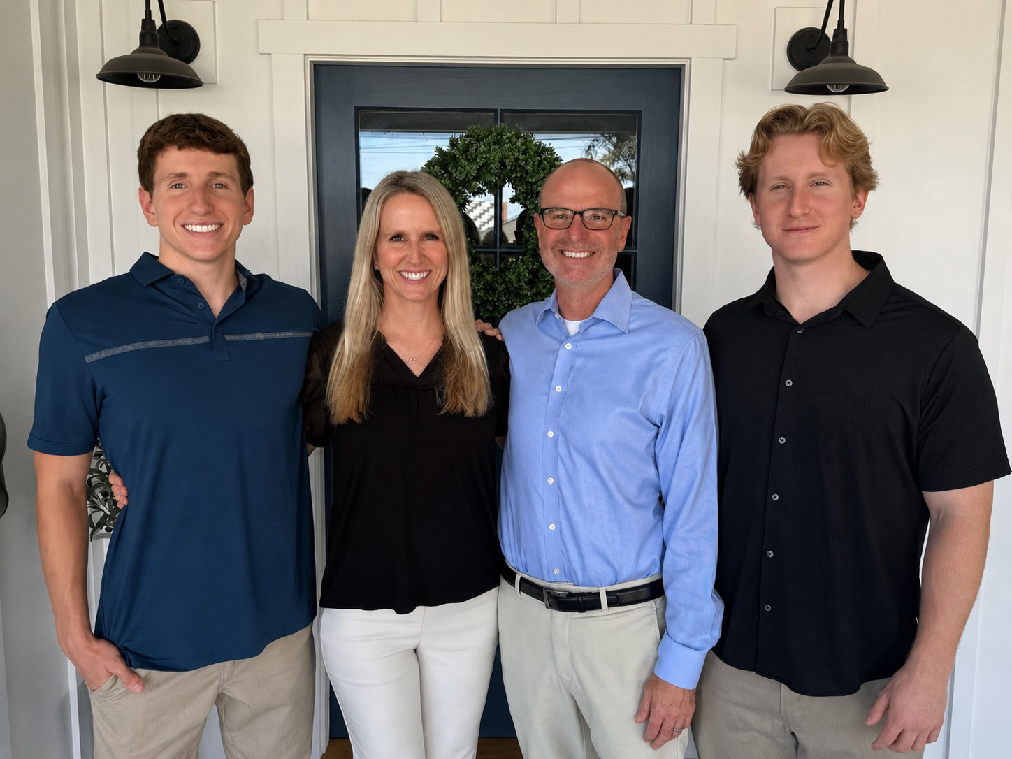 Ryan Baldino with Kara and their two sons, the four of them standing together and smiling at the camera