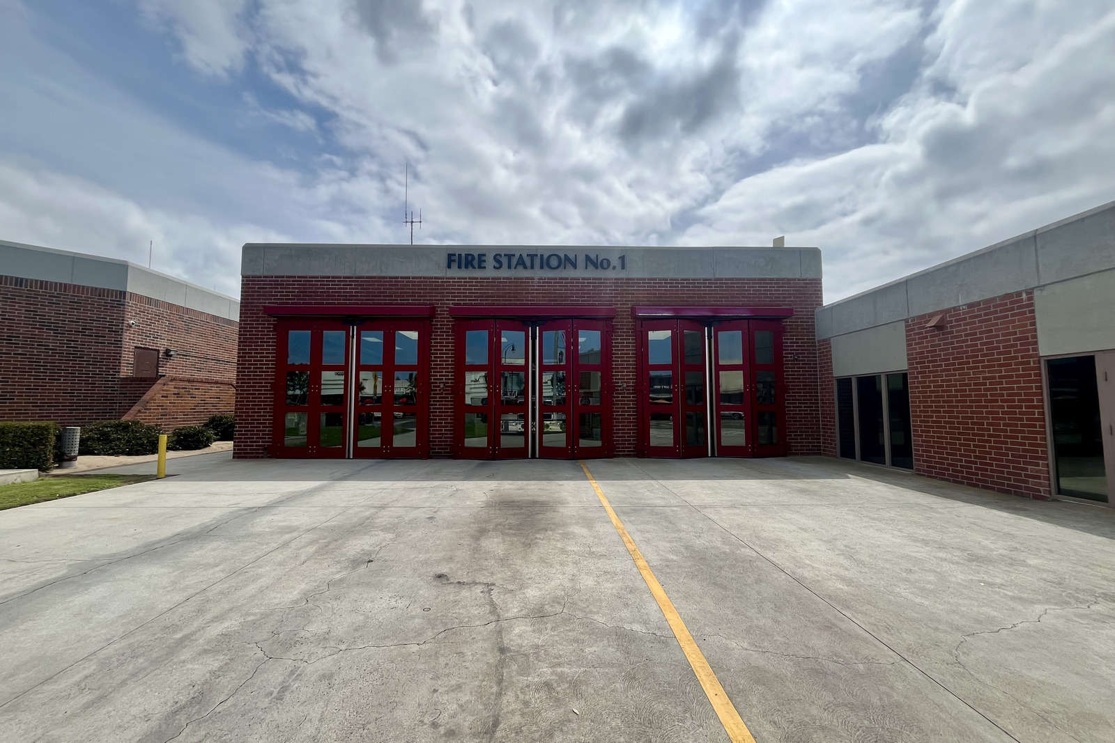 El Segundo Fire Station No. 1 seen head on, its three red apparatus doors closed beneath the station name