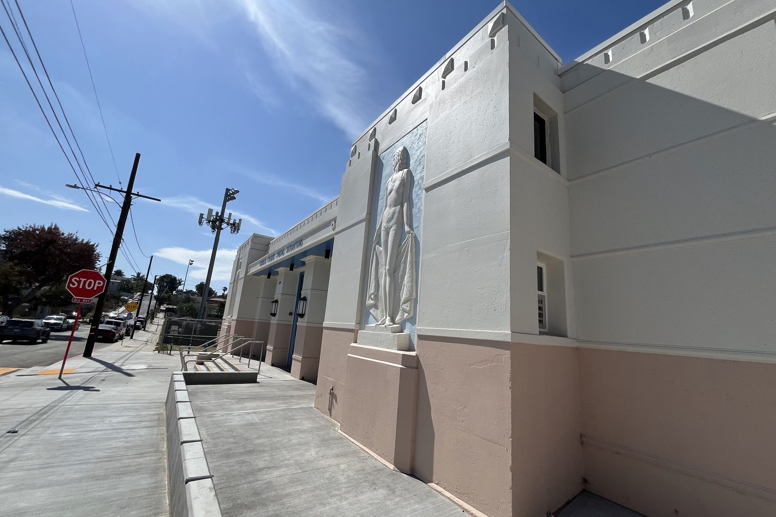 The exterior of the Urho Saari Swim Stadium showing one of its art deco relief figures on the corner wall.